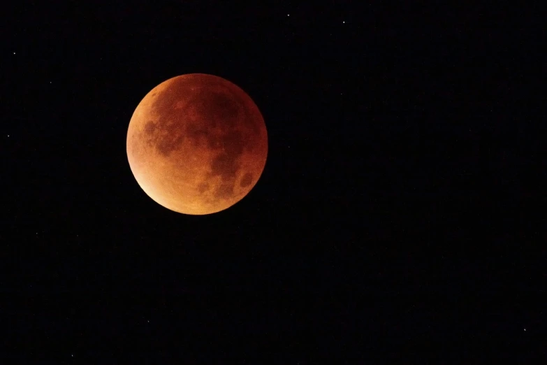 a blood moon is seen in the night sky, by Steven Belledin, hurufiyya, usa-sep 20, afp