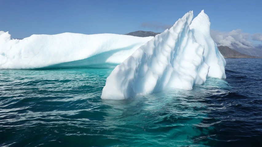 a large iceberg floating in the middle of the ocean, precisionism, blue and green water, white desert, rippling water, icicle