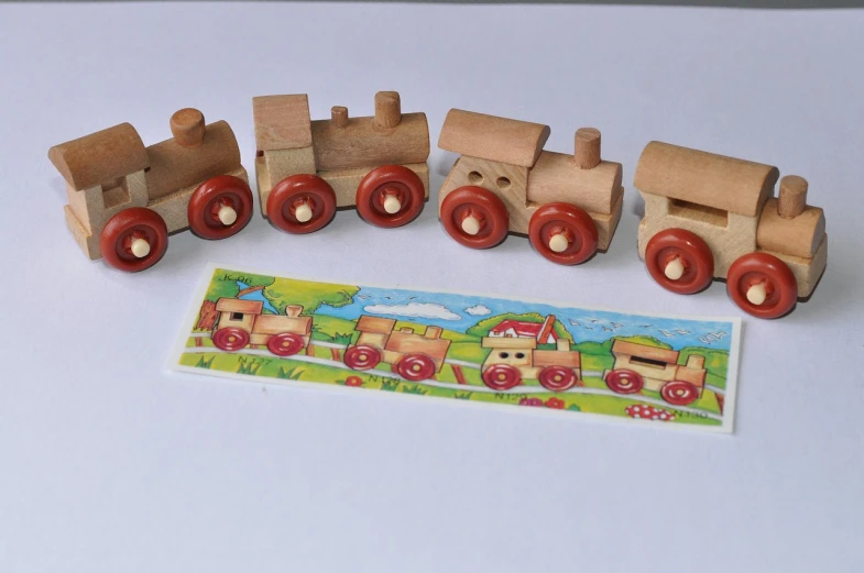 a close up of a toy train on a table, a picture, figuration libre, wooden banks, front back view and side view, card, without duplication