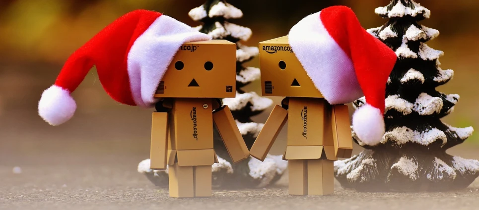 a couple of boxes sitting next to a christmas tree, by Krzysztof Boguszewski, pixabay, happening, focus on two androids, amazon, chibi, instagram photo