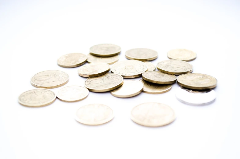 a pile of coins sitting on top of a white surface, a picture, close-up product photo, stockphoto, product photo