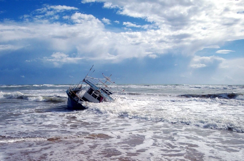 a boat sitting on top of a beach next to the ocean, a picture, by Richard Carline, violent stormy waters, broken down, istockphoto, dredged seabed