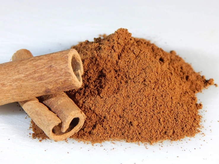 a pile of cinnamon sticks next to a pile of cinnamon powder, a digital rendering, pexels, dau-al-set, vine, product introduction photo, 💣 💥, viewed from below