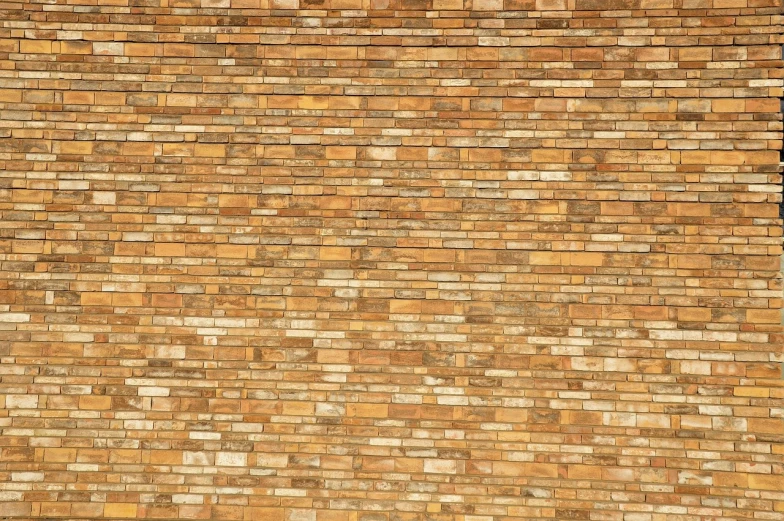 a red fire hydrant sitting in front of a brick wall, inspired by Andreas Gursky, minimalism, earthtone colors, stylized stone cladding texture, light - brown wall, many golden layers