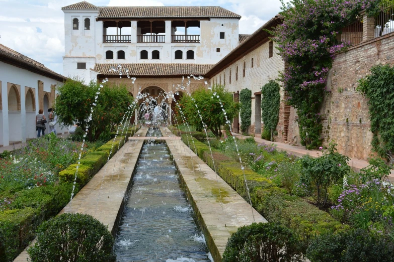 a water fountain in a courtyard with a building in the background, inspired by Luis Paret y Alcazar, renaissance, stream flowing through the house, gardens with flower beds, inhabited on many levels, colonnade