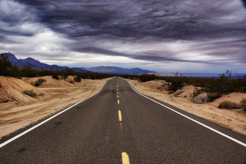 an empty road in the middle of the desert, a picture, flickr, realism, cloud, los angeles, computer wallpaper, grain”