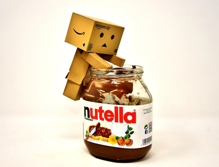 a couple of boxes sitting on top of a jar of nutella, a picture, by Goro Fujita, tumblr, stop motion vinyl figure, ((oversaturated)), chocolate. rugged, programming