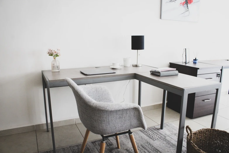 a chair that is sitting in front of a desk, by Romain brook, pexels, grey color scheme, corner, fully functional, on a white table