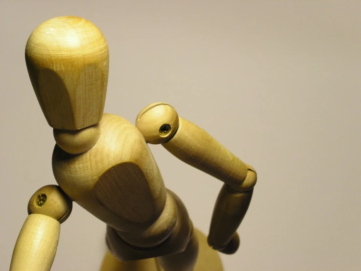 a wooden mannequin standing in front of a white wall, a macro photograph, flickr, articulated joints, [ closeup ]!!, toy photography, woodturning