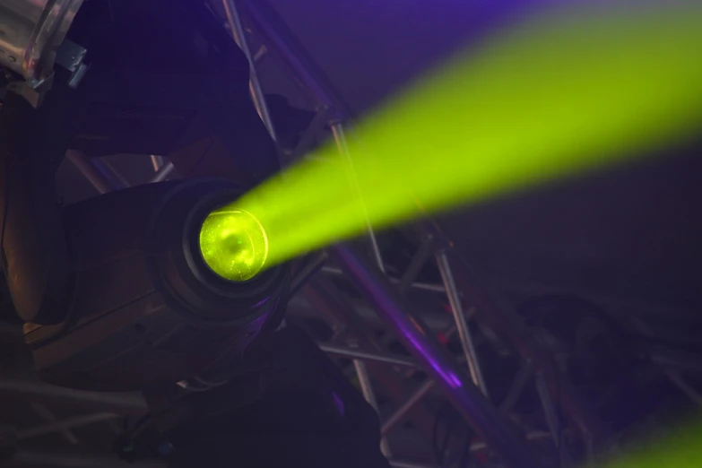 a close up of a green light on a stage, shutterstock, laser cannon, purple and yellow lighting, dramatic lighting from below, taken with a pentax1000