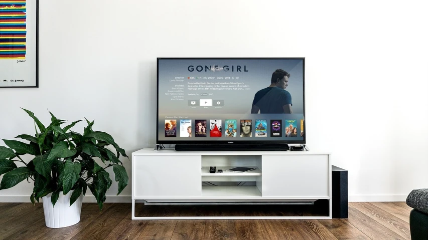 a flat screen tv sitting on top of a white entertainment center, a cartoon, pexels, movie poster, next gen, promotional movie still, lowres