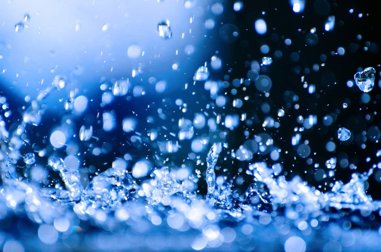 a close up of water droplets on a surface, a picture, shutterstock, bursting with blue light, high quality product image”