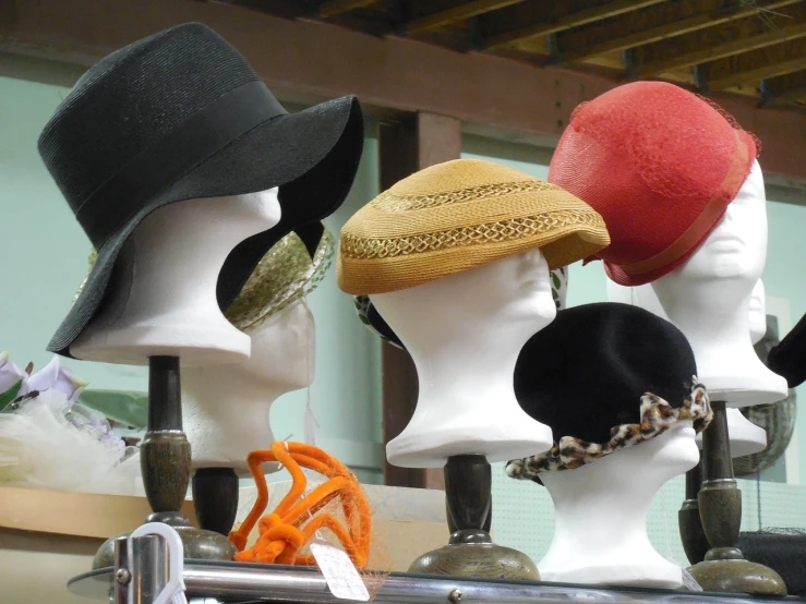 a group of mannequin heads with hats on them, flickr, 2070s, curves, full colour, left profile