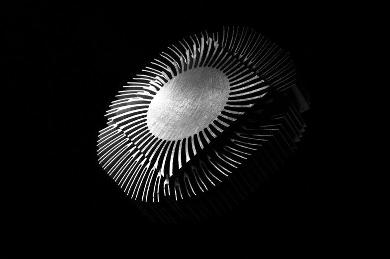 a black and white photo of a fan in the dark, an abstract sculpture, by Mirko Rački, computer art, cpu gpu wafer, sunshine light, aluminum, a wooden