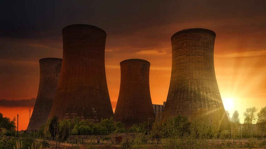 a couple of cooling towers sitting in the middle of a field, by Matt Stewart, pexels contest winner, nuclear art, sundown, brown, pillars, shodan