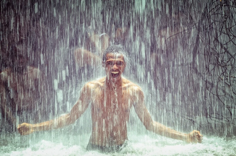 a man that is standing in the water, by Jan Rustem, pexels contest winner, conceptual art, brutal joyful face expression, under waterfall, summer rain, happy people