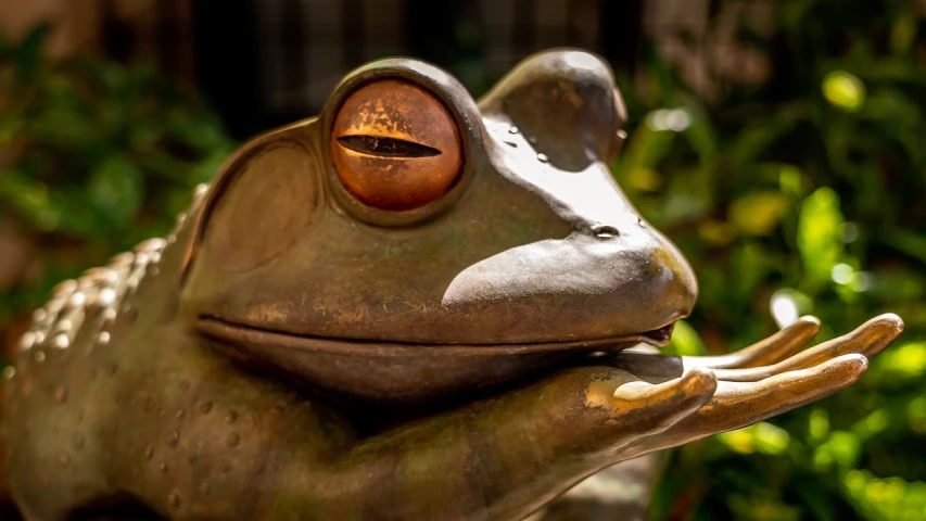 a close up of a statue of a frog, a bronze sculpture, by Robert Brackman, unsplash, photorealism, high resolution details, bali, “portrait of a cartoon animal, copper and brass