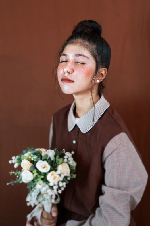 a woman with her eyes closed holding a bouquet of flowers, a character portrait, inspired by Kim Jeong-hui, unsplash, realism, brown shirt, studio photo portrait, portrait of a japanese teen, indoor picture