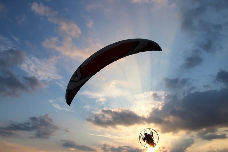 a person that is flying a kite in the sky, a picture, flickr, buggy, sunset photo, hyperdetailed!, parachutes