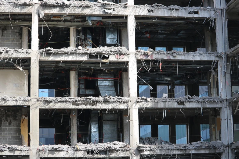 a very tall building with a bunch of windows, by Richard Carline, flickr, brutalism, destroyed robot dogs remains, shot on 1 5 0 mm, rubble!!, te pae