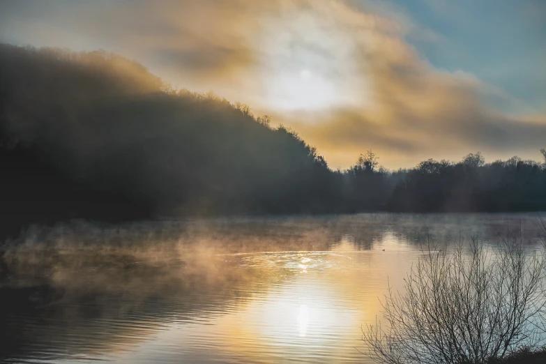 a large body of water next to a forest, a photo, romanticism, early morning sunrise, iowa, rising steam, full subject shown in photo