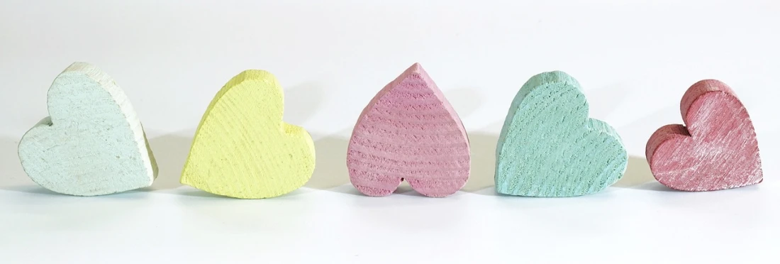 a row of wooden hearts sitting next to each other, flickr, pastel colorful mold, hoshino yukinobu, product introduction photo, viewed from behind