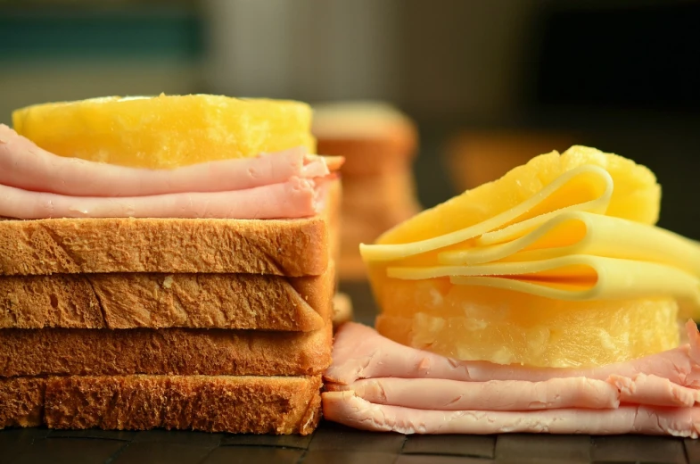 a close up of a sandwich with cheese and ham, a picture, by Bernardino Mei, pexels, minimalism, yellow, sliced grapefruit, stacks, istock