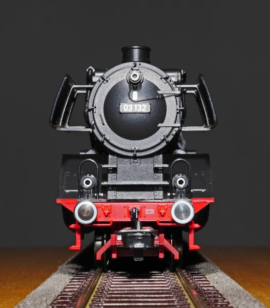 a close up of a toy train on a track, a portrait, by Jörg Immendorff, photorealism, high detail product photo, bottom view, steam engine, highly detailed product photo