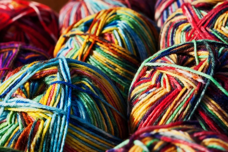 a pile of multicolored yarn sitting on top of each other, inspired by Toss Woollaston, pexels, full of colour 8-w 1024, sun shining, rich deep vivid colours, stunning lines