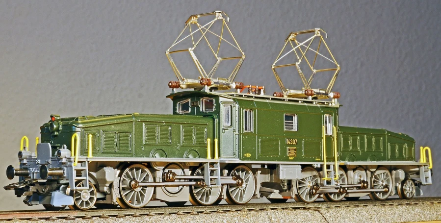 a green train sitting on top of a train track, a pastel, by Hans Schwarz, flickr, figuration libre, electric motors, highly detailed model, loose wires, side profile