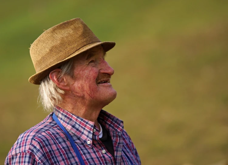 a close up of a person wearing a hat, by Peter Scott, tall farmer, laughingstock, peaceful expression, scotland