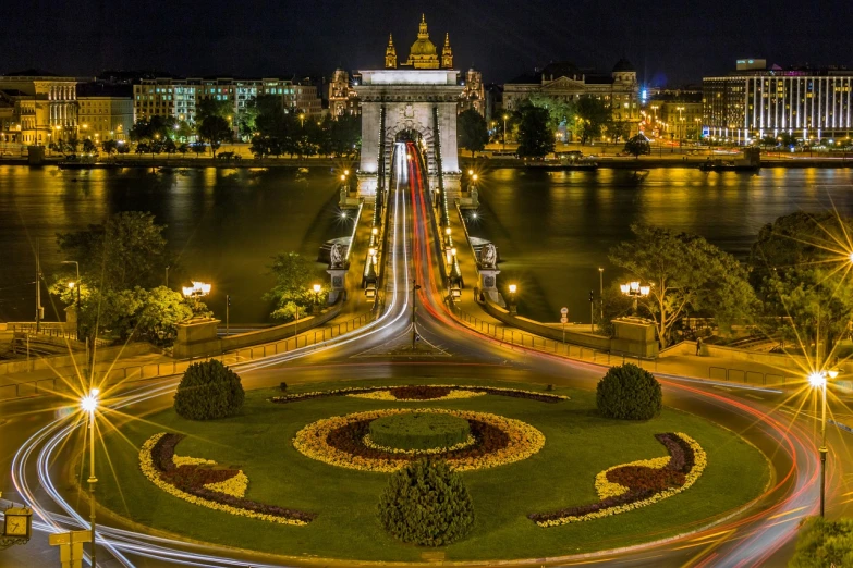 a view of a bridge over a river at night, by Adam Szentpétery, pexels contest winner, art nouveau, birds - eye view, austro - hungarian, gate, christian saint