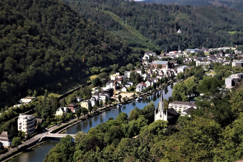 a river running through a lush green hillside, heidelberg school, realistic photo of a town, with trees and rivers, isomeric view, woodstock