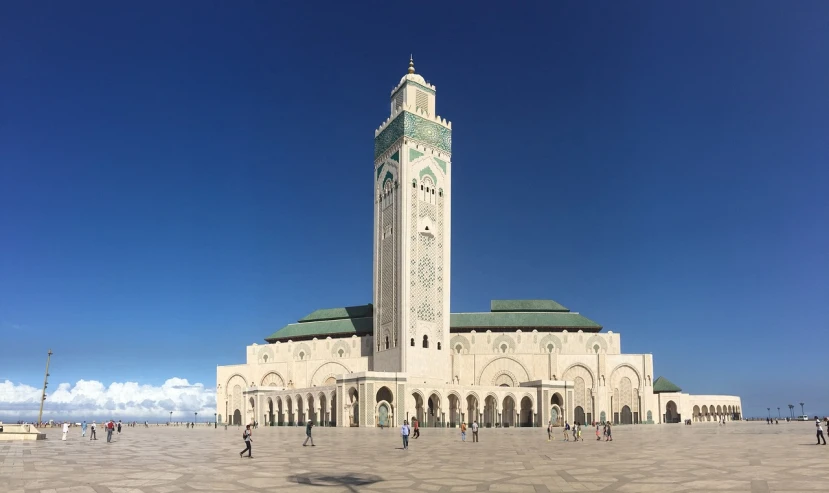 a large white building with a clock tower, a picture, arabesque, moroccan mosque, wide panoramic shot, photo taken in 2018, many columns