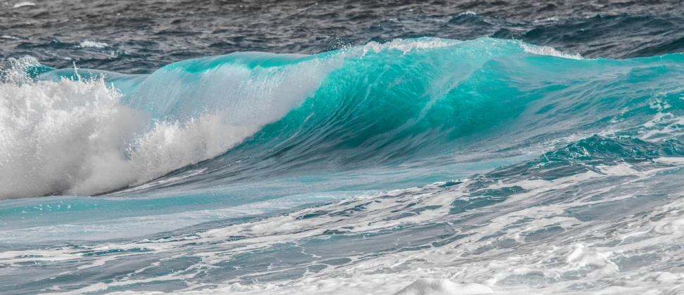 a man riding a wave on top of a surfboard, by Peter Churcher, pexels, fine art, turquoise palette, ( ( ( kauai ) ) ), charybdis, glassy fracture