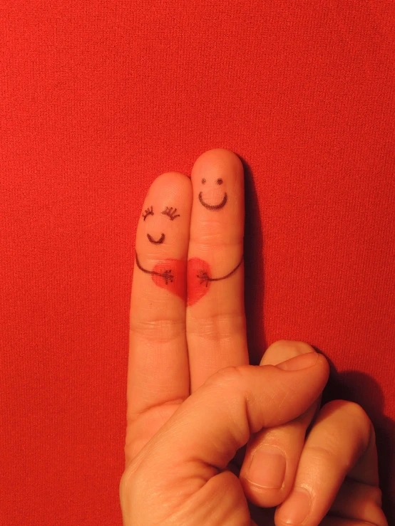 a person making a peace sign with their fingers, by Jan Rustem, flickr, romanticism, happy couple, cute bandaid on nose!!, red hearts, little people!!!