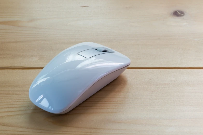 a white computer mouse sitting on top of a wooden table, a picture, minimalism, highly detailed product photo, half body photo