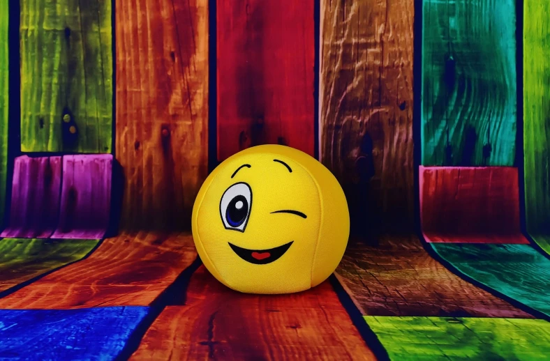 a yellow ball sitting on top of a wooden floor, a picture, inspired by Sam Havadtoy, pexels, toyism, laughing emoji, pretty oval face, fumo plush, colorful hd picure