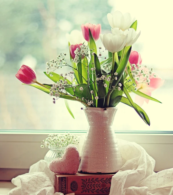 a vase filled with flowers sitting on top of a window sill, a picture, pexels, romanticism, roses and tulips, cute and lovely, pink white and green, flowers grow from the body