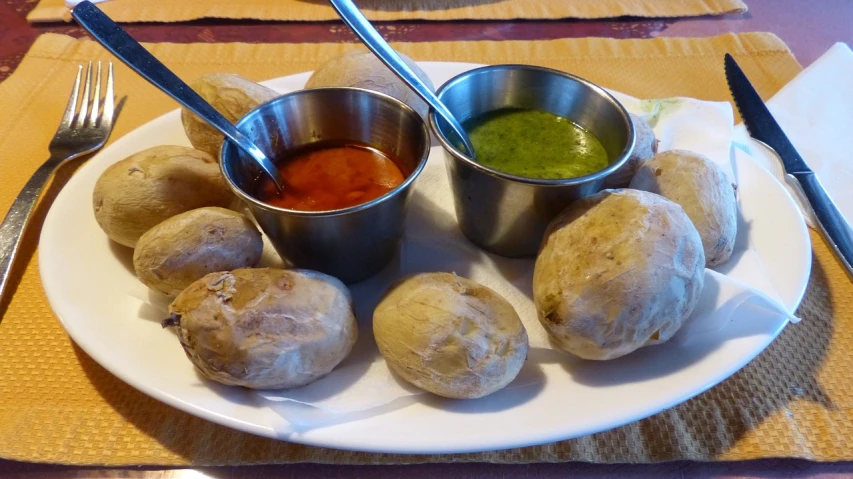 a white plate topped with potatoes and dipping sauce, by Victoria Francés, flickr, colours red and green, indian, albuquerque, puffballs