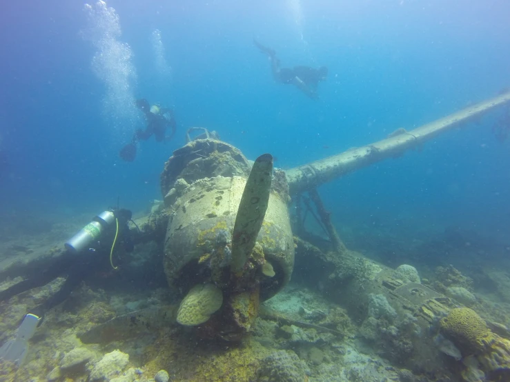 a large propeller sitting on top of a coral reef, a picture, dada, humans hide in the underwater, aircraft, wide shot photo