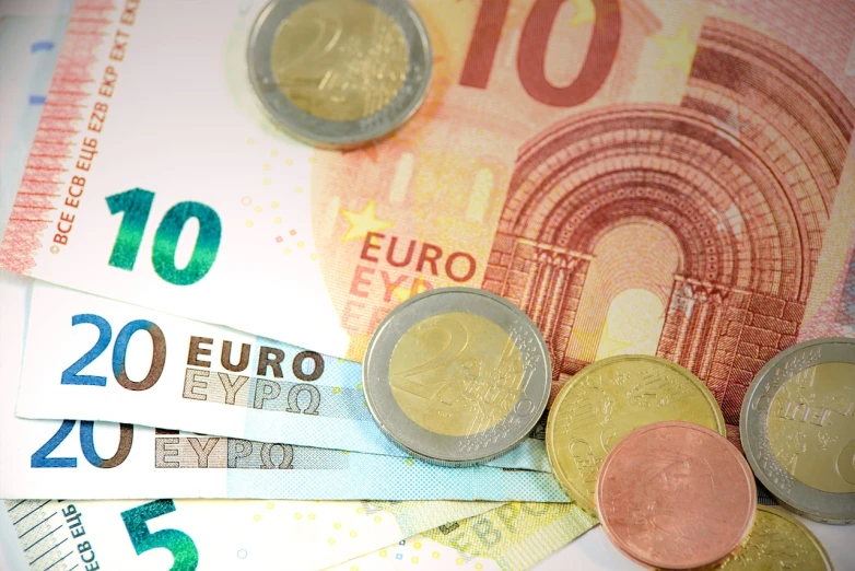 a bunch of money sitting on top of a table, by Konrad Klapheck, celtic, european union, nice colors, lowres