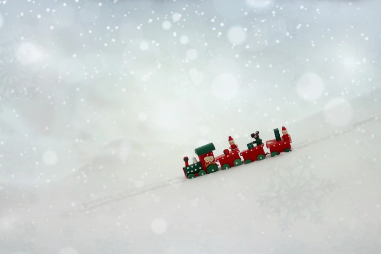 a toy train sitting on top of a snow covered ground, by Emma Andijewska, flickr, folk art, stopmotion animation, digital render, red and green hour, santa