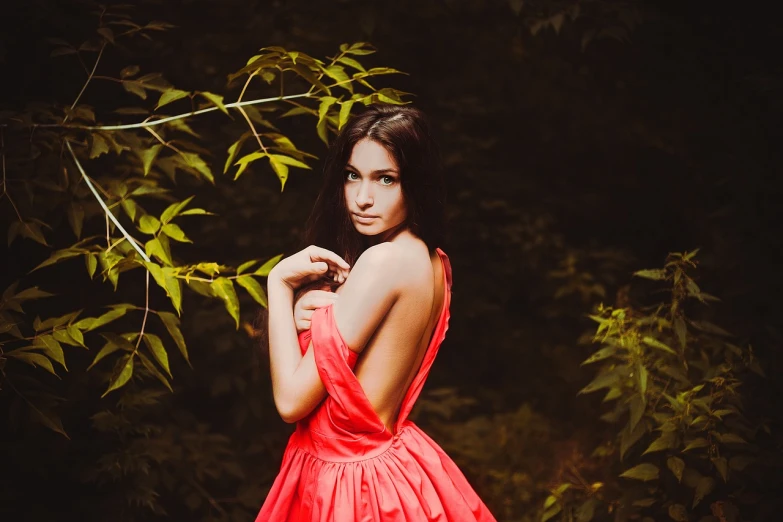 a woman in a red dress posing for a picture, a picture, by Zofia Stryjenska, tumblr, romanticism, young woman with long dark hair, amongst foliage, beautiful sexy woman photo, neon colored dress