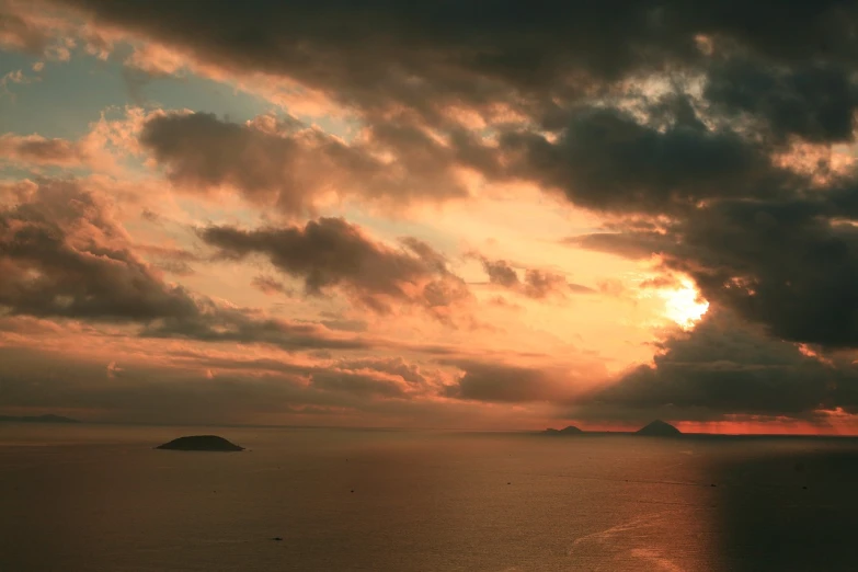 a large body of water under a cloudy sky, a picture, romanticism, sunset kanagawa prefecture, two medium sized islands, gulf of naples, taken with a pentax1000