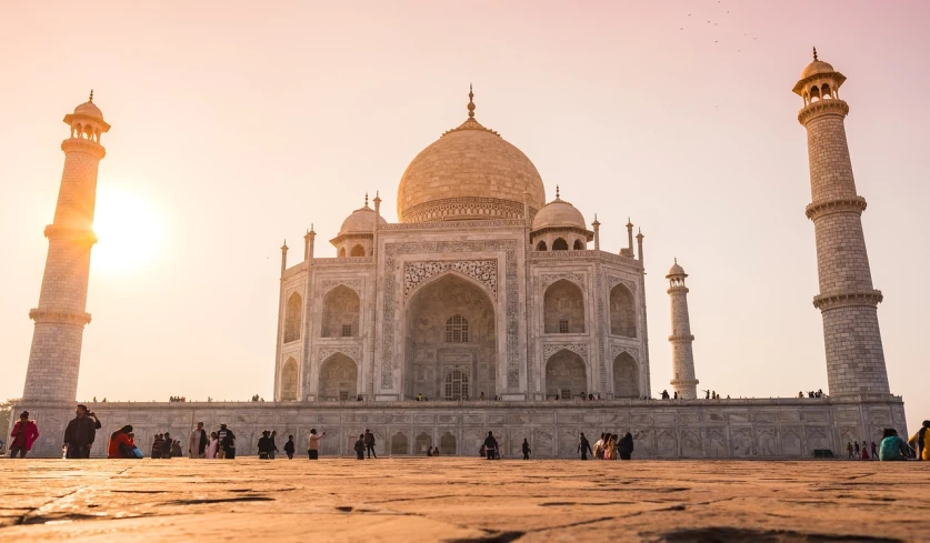 a group of people standing in front of a building, inspired by Steve McCurry, pexels contest winner, renaissance, taj mahal made of cheese, golden hour scene, background image, on a marble pedestal