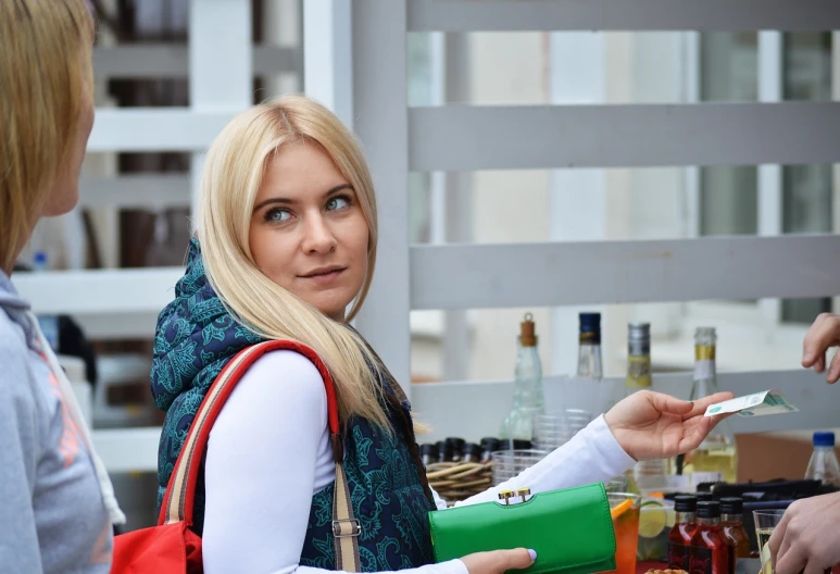 a couple of women standing next to each other at a table, by Anna Katharina Block, instagram, happening, blond hair green eyes, shopping groceries, uhd candid photo of dirty, russian girlfriend