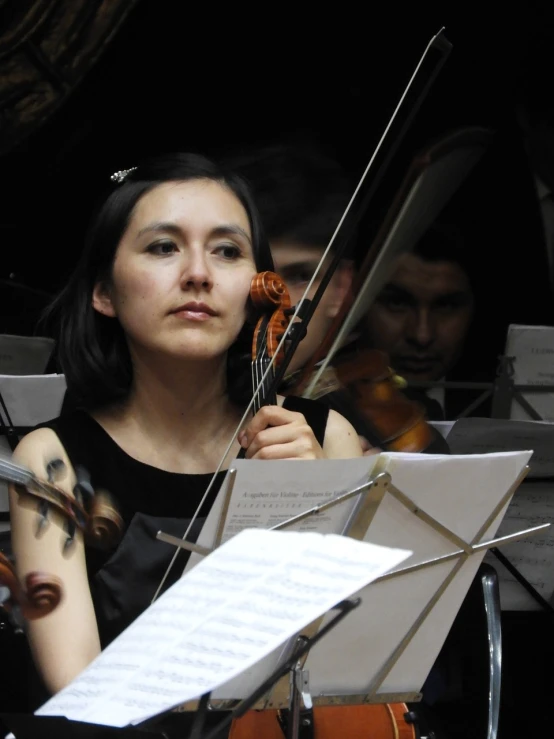 a woman in a black dress holding a violin, by Maksimilijan Vanka, flickr, orchestra, closeup - view, ayanamikodon and irakli nadar, 2 0 1 0 photo