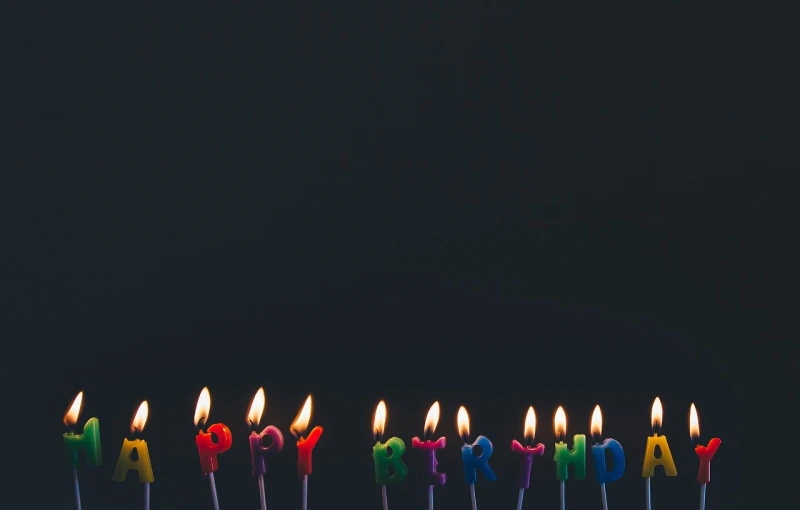 a group of birthday candles sitting on top of a cake, by Jesper Knudsen, pexels, minimalist wallpaper, wide screenshot, photo taken in 2018, banner