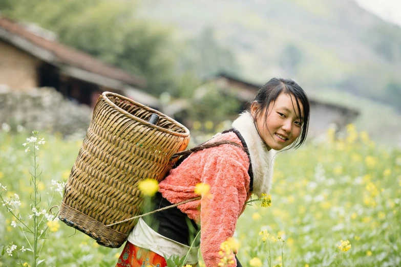 a woman carrying a basket in a field of flowers, inspired by Miao Fu, flickr, environmental portrait, warm smile, family, honey